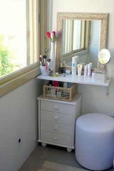 a bathroom with a vanity, mirror and toiletries on the counter next to it