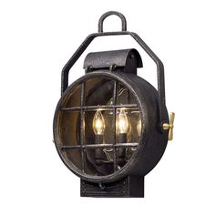 an old fashioned light fixture with two bulbs on the front and one bulb in the middle