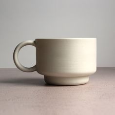 a white cup sitting on top of a table