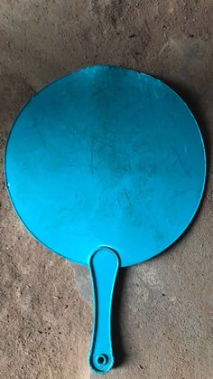 a blue spatula sitting on the ground