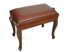 a wooden bench with brown leather seat cushion