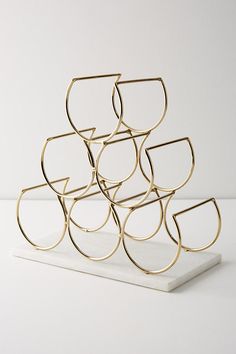 a stack of gold rings sitting on top of a white table