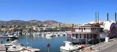 boats are docked in the water at a marina