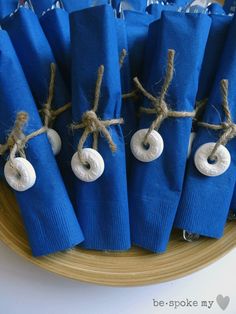 blue napkins tied with twine and white donuts on top of each other