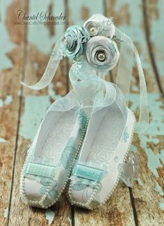 a pair of baby shoes sitting on top of a wooden floor