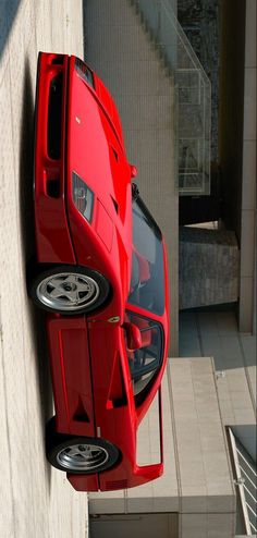 a red sports car parked on the side of a building