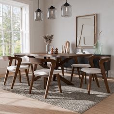 a dining room table with four chairs and a rug on the floor in front of it