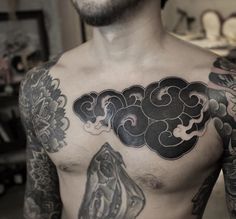 a man with lots of tattoos on his chest