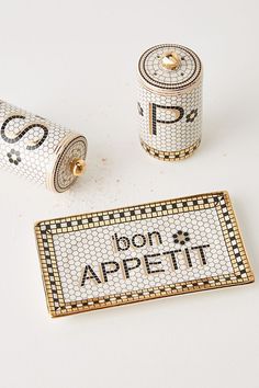 two pins with the words don't appetit written in gold on them