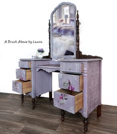 a purple vanity with drawers and a mirror