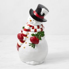 a snowman figurine wearing a top hat and scarf