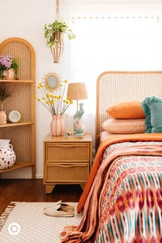 a bedroom with wicker furniture and flowers on the nightstands next to the bed