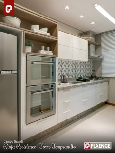 a modern kitchen with white cabinets and stainless steel appliances, is featured in the ad