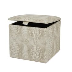 an upholstered storage box with a black lid and handles on the front, in white crocodile skin