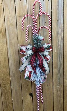 a candy cane hanging on the side of a wooden fence