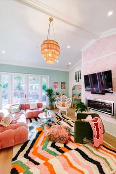 a living room filled with lots of furniture and a flat screen tv mounted on the wall