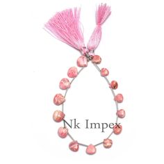 a bracelet with pink beads and tassels is shown in the shape of a circle