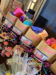 many bags with name tags on them sitting on a table