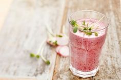 a drink with strawberries in it sitting on a table