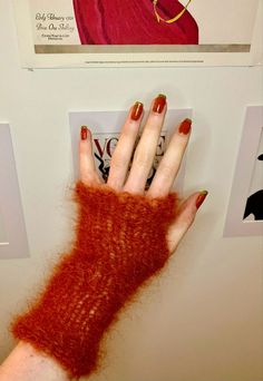 a woman's hand with red nail polish holding onto a light switch cover in front of a poster