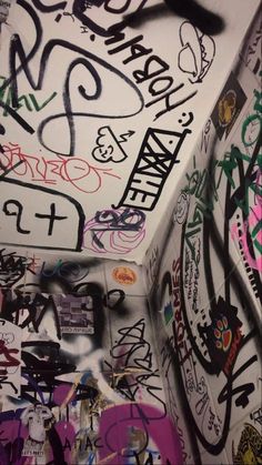 graffiti on the side of a toilet in a bathroom