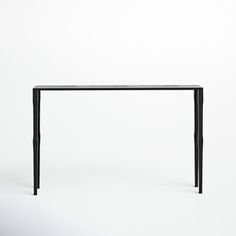 a black table sitting on top of a white floor