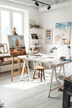 an artist's studio with easels and paintings