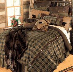 a bed with plaid comforter and pillows in a rustic style bedroom, along with an animal - themed throw pillow