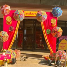 an entrance decorated with colorful umbrellas and decorations