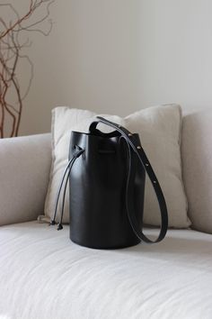 Whether you're heading to a café in the morning, taking a stroll through the park or meeting up with friends - the sustainable bucket bag is the ideal companion for every moment. With its clear and timeless design, it blends effortlessly into any wardrobe and quickly becomes an indispensable accessory. Made from vegetable-tanned leather, each bag is unique and will only become more individual and unique with time. Thanks to the practical drawstring, the pouch bag can be closed securely, while the spacious interior offers plenty of room for all your essentials. The comfortable, adjustable shoulder strap allows it to be worn crossbody or over the shoulder. Handmade with care and consideration in my Hamburg studio, the leather bag combines traditional craftsmanship with modern, sustainable de Leather Bucket Bag, Leather Bucket, The Pouch, Pouch Bag, Vegetable Tanned Leather, Leather Crossbody Bag, Modest Fashion, Purses And Handbags, Leather Crossbody