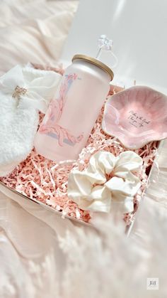 a pink and white gift box filled with personal care items