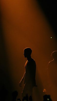 a man standing in front of a crowd at a concert