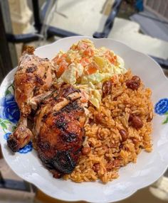 a white plate topped with meat and rice