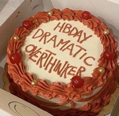 a birthday cake in a box with the words hbday dramatic okehnker written on it