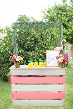 an outdoor bar with pineapples, lemons and watermelon on it