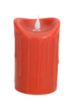 an orange candle with a white flame on it's top and the bottom is dripping