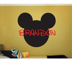 a mickey mouse head with the word brandon painted on it's face in red and black