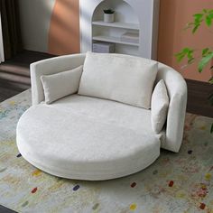 a white round chair sitting on top of a rug