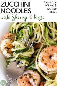 zucchini noodles with shrimp and pesto in a white bowl with a fork