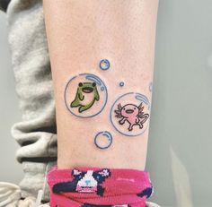 a person with a tattoo on their arm that has fish and bubbles in it,