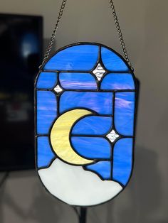 a stained glass window hanging from a chain