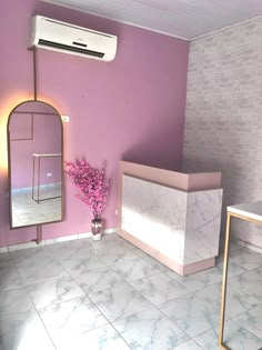 a bathroom with purple walls and marble flooring, including a mirror on the wall