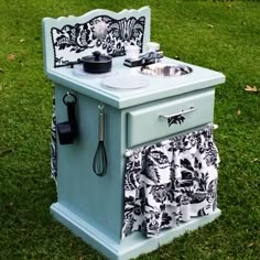 an old fashioned stove is painted blue and has black and white designs on the front