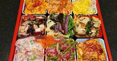 an assortment of different types of food in trays