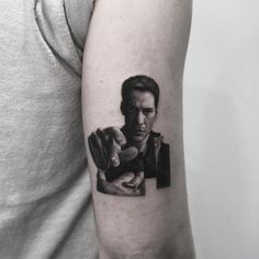 a man's arm with a portrait of the actor, in black and white