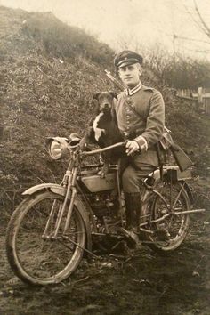 an old black and white photo of a man on a motorcycle with his dog