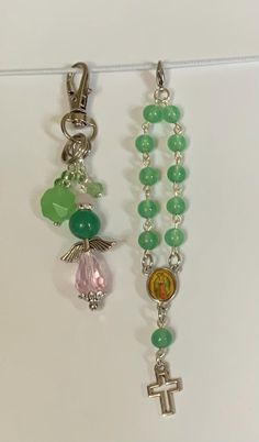 two rosarys with beads and charms hanging from them