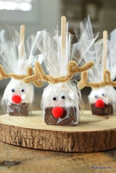 reindeer candies are wrapped in clear cellophane and placed on a wooden board