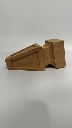 a wooden object on a white surface with no one around it and the top section missing