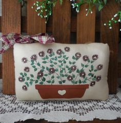 a pillow with flowers on it sitting on a table